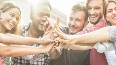 An image showing a team putting their hands together