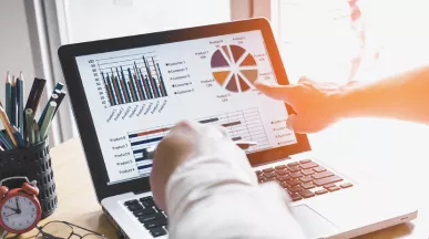 Two people looking at data on a computer