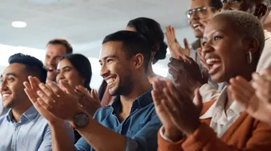 Shows several people clapping the same direction