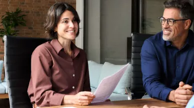 A new employee getting set up with paperwork during onboarding