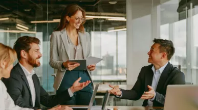 A high performing team at work collaborating and brainstorming around a table.