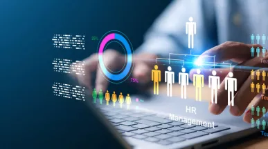 A HR professional on their laptop working on human resources management tasks